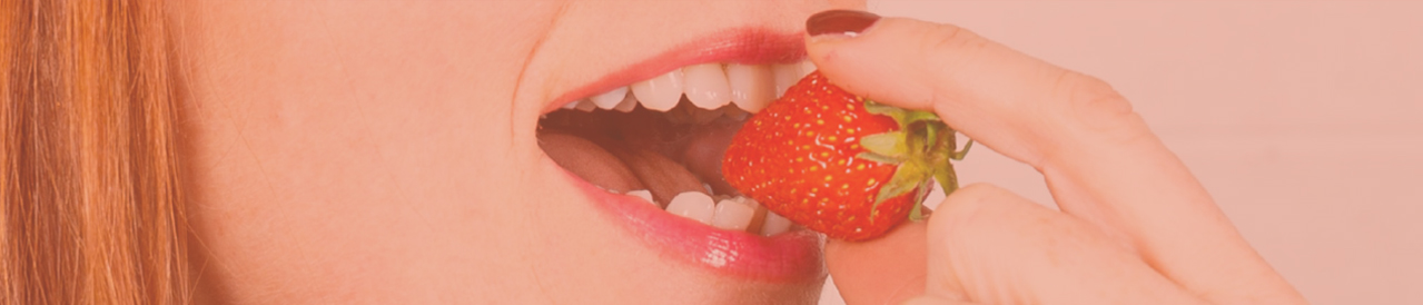 Photo d'une d'une femme entrain de manger une fraise